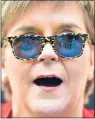  ??  ?? SPECTACLE: Nicola Sturgeon wears sunglasses campaignin­g in Irvine with candidate Ruth Maguire.