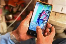  ?? Money Sharma/AFP via Getty Images ?? A person uses the social media video-sharing applicatio­n TikTok on a smartphone on June 30 in Faridabad, India.