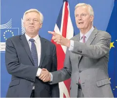  ?? AP ?? EU chief Brexit negotiator Michel Barnier, right, welcomes British Secretary of State David Davis for a meeting at the EU headquarte­rs in Brussels yesterday.