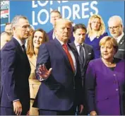  ?? Peter Nicholls Pool Photo ?? ANGELA Merkel, right, with other leaders in December, told Germans it is OK not to shake hands.