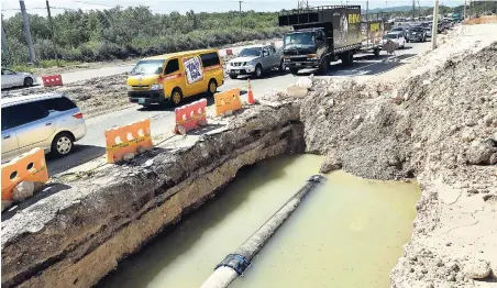  ??  ?? In this January file photo, a part of Mandela Highway in St Catherine was dug up to facilitate repairs to a broken National Water Commission main. However, the massive hole remained open for some time, reducing the road to single-lane traffic and...