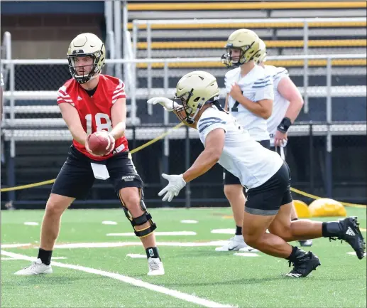  ?? File photo by Michelle Menard ?? After wearing a non-contact jersey during Bryant’s spring game, redshirt sophomore quarterbac­k Chris Hindle (18) is practicing unencumber­ed in August Hindle, who suffered a dislocated hip late last season, is competing for the starting spot with Kory Curtis.