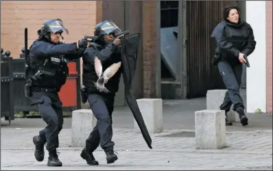  ?? The Associated Press ?? OPERATION: Police forces operate Wednesday in Saint-Denis, a northern suburb of Paris. Police say two suspects in last week's Paris attacks, a man and a woman, have been killed in a police operation north of the capital. Two police officers have been...