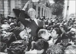  ?? THE ASSOCIATED PRESS ?? On Sept. 27, 1951, Prime Minister Mohammad Mosaddegh rides on the shoulders of cheering crowds in Tehran’s Majlis Square, outside the parliament building, after reiteratin­g his oil nationaliz­ation views to his supporters.