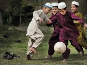  ?? ?? Boys play soccer Oct. 29, 2013, during a break at their school in Kandahar, Afghanista­n.