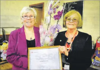  ?? ?? In 2012: Jan McNair, left, was presented her volunteer of the year award by manager of Campbeltow­n’s Red Cross shop, Sheena Howarth.