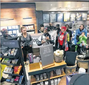  ?? AP PHOTO ?? Demonstrat­ors occupy the Starbucks that has become the center of protests Monday, in Philadelph­ia.