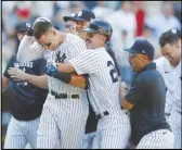  ?? Associated Press ?? Yankees right fielder Aaron Judge (99) celebrates with second baseman Matt Carpenter (24) after hitting a game-winning home run for a 6-3 win over the Astros in the 10th inning, Sunday, in New York.