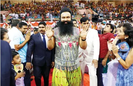  ??  ?? In this file photo dated Oct. 5, 2016, the convicted Indian guru who calls himself Dr. Saint Gurmeet Singh Ram Rahim Insan, center, greets followers as he arrives for a press conference ahead of the release of his movie. (AP)