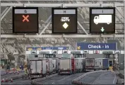  ?? GARETH FULLER — PA ?? Trucks enter the ferry terminal at Port of Dover, in southern England, the main ferry link with France and other northern Europe ports, late Thursday.