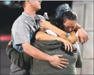  ?? Ethan Miller/ Getty Images ?? People hug and cry outside the Thomas & Mack Center after a mass shooting at the Route 91 Harvest country music festival on Monday in Las Vegas.