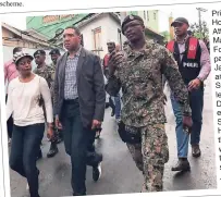  ??  ?? Prime Minister Andrew Holness is flanked by Attorney General Marlene Malahoo Forte, member of parliament for St James West Central, and Major Godphey Sterling, who is leading the Jamaica Defence Force’s efforts in Mount Salem, St James. Holness was...