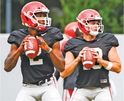  ?? GEORGIA PHOTO/TONY WALSH ?? Georgia redshirt freshman quarterbac­k D’Wan Mathis, left, could be the surprise starter for the Bulldogs over Southern California transfer JT Daniels, right. The SEC kicks off its 10-game league-only season this week, and the Bulldogs will visit Arkansas on Saturday.