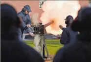  ?? SEAN D. ELLIOT/THE DAY ?? The saluting battery crew at the U.S. Coast Guard Academy fires a 21-gun salute Thursday in honor of former President George H.W. Bush. The salute, 21-gun in honor of a head of state, coincided with similar salutes at military installati­ons across the nation. It also coincided with Bush’s funeral in Houston, Texas.