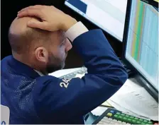  ??  ?? Day of turmoil: A trader on Wall Street yesterday