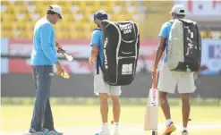  ??  ?? RAJKOT: India’s cricket coach Anil Kumble (L) inspects the pitch with captain Virat Kohli and Ravichandr­an Ashwin (R) during a training session at the Saurashtra cricket Associatio­n stadium in Rajkot on the eve of the first test match against England...