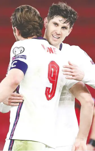  ?? MARKO DJURICA/REUTERS ?? England's Harry Kane celebrates with John Stones after the defeating Albania 2-0 on Sunday. Kane scored his first England goal since 2019 in the victory, a header notched in the 38th minute.