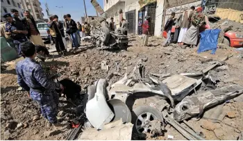  ?? — AFP photo ?? Yemenis inspect the site of reported Saudi-led airstrikes targeting the Huthi-controlled capital Sanaa.