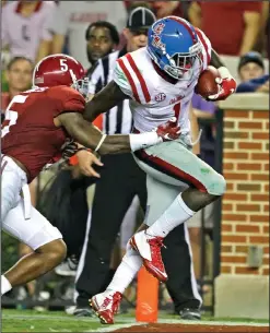  ??  ?? Mississipp­i wide receiver Laquon Treadwell, right, catches a pass for a touchdown over Alabama defensive back Cyrus Jones.