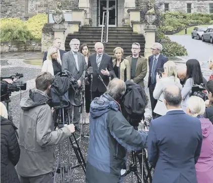  ??  ?? 0 Martin Mcguinness (centre) and Gerry Adams (left) respond outside Stormont to news of the Brexit vote