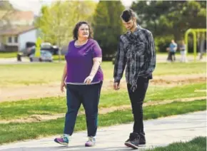  ?? Joe Amon, The Denver Post ?? Elizabeth Pate, 58, and her 22-yearold adopted son, Stephen Morgan, walk in a park near their home in Broomfield last month. Stephen says that when he’s older, he will adopt foster teens. He also hopes someday to find his siblings.