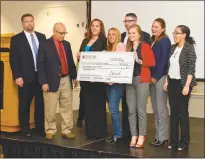  ?? STAFF PHOTOS BY DARWIN WEIGEL ?? The Planting Hope team holds the $500 check for second place with the Neilom Foundation’s Dylan Hazelwood, far left, and Davinder K. Anand.