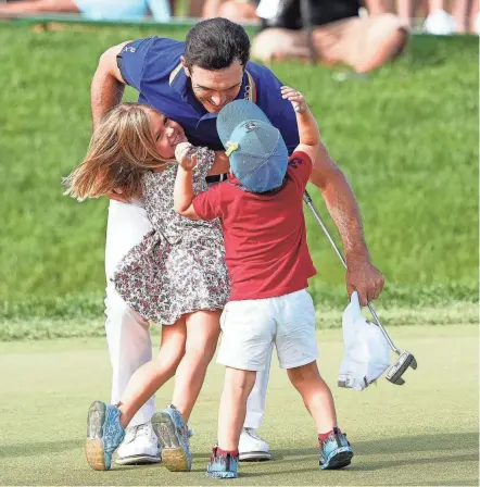  ?? KYLE ROBERTSON/COLUMBUS DISPATCH ?? Billy Horschel hugs his daughter Colbie and son Axel after winning the Memorial Tournament on Sunday.