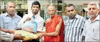  ??  ?? Fashion Bug Director Shabier Subian (second from left) handing over basic necessitie­s to the temple chief