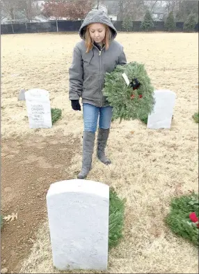  ?? COURTESY PHOTO ?? Abby Dismang, a member of Farmington FFA, helps to place wreaths in memory of veterans and family members.
