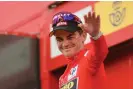  ?? Photograph: Manuel Bruque/EPA ?? Sepp Kuss, wearing the overall leader’s red jersey, celebrates on the podium after the stage.
