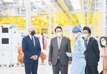  ?? KIM MIN-HEE/POOL PHOTO VIA AP ?? President Joe Biden and South Korean President Yoon Suk Yeol, center, tour the Samsung Electronic­s semiconduc­tor factory Friday in Pyeongtaek. Biden has started a five-day tour of South Korea and Japan.