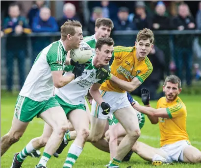  ??  ?? Cian Surlis of Tourlestra­ne tries to stop a St Molaise Gaels attack as Mark Quinn and Daragh Gallagher move forward during the Belfry Senior Football Championsh­ip Quarter Final in Bunninadde­n on Sunday. Pics: Tom Callanan.