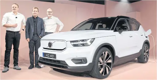  ?? AP ?? FROM LEFT Henrik Green, chief technology officer, Hakan Samuelsson, CEO, and Bjorn Annwall, head of the EMEA region and global commercial operations, stand next to the XC40 Recharge during an event in Los Angeles on Wednesday.