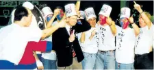  ?? SUPPLIED PHOTO ?? A CHCH Television reporter wears the headgear made famous by the Brock Buckethead­s, a group of fans who helped push the Badgers men's basketball team to a national championsh­ip in 1992.