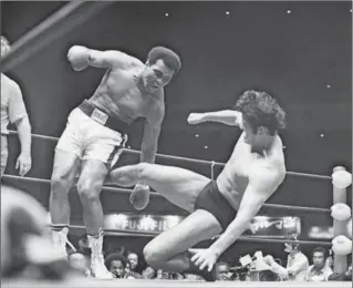  ?? GETTY IMAGES FILE PHOTO ?? The original mixed combat sports event, and likely the reason there haven’t been any since. Muhammad Ali was looking for a payday in 1976 when he agreed to meet pro wrestler Antonio Inoki in a 15-round match in Tokyo.