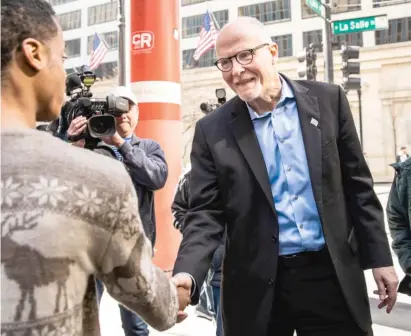  ?? ASHLEE REZIN/SUN-TIMES ?? Mayoral candidate Paul Vallas greets constituen­ts Wednesday outside the Thompson Center in the Loop.