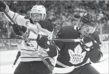  ?? STEVE RUSSELL TORONTO STAR FILE PHOTO ?? Leaf Zach Hyman, battling Brendan Guhle of the Sabres, learned to become a more rounded player at the University of Michigan.