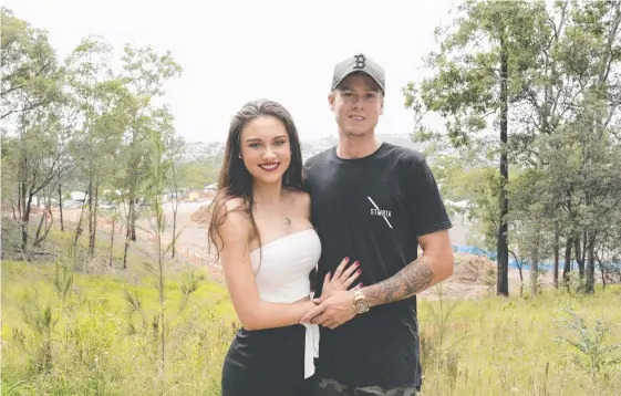  ??  ?? Holly Power, 20, and Alex Hart, 21, are the first and youngest couple to buy land in the newly released Harriet Lane estate in Oxenford.