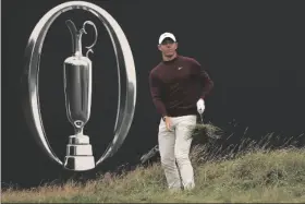  ?? AP PHOTO/PETER MORRISON ?? Northern Ireland’s Rory McIlroy chips onto the 18th green from the rough during a practice round for the British Open Golf Championsh­ips at the Royal Liverpool Golf Club in Hoylake, England, on Tuesday.