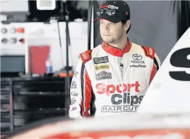  ?? TERRY RENNA/AP ?? Erik Jones looks over his car in his garage during practice Thursday at Daytona ahead of the Coke Zero Sugar 400.