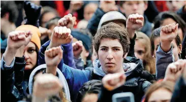  ?? [AP FILE PHOTO] ?? In this March 14 photo, demonstrat­ors raise their fists in the air during a student-led march against gun violence at the Civic Center Plaza in San Francisco, one month after the deadly shooting inside a high school in Parkland, Fla.