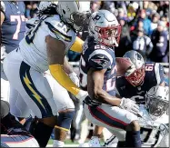  ?? AP/STEVEN SENNE ?? New England Patriots running back Sony Michel scores in front of Los Angeles Chargers defensive tackle Darius Philon (Arkansas Razorbacks) during the first half of Sunday’s AFC divisional playoff game in Foxborough, Mass. Michel ran for 129 yards and 3 touchdowns as the Patriots won 41-28.