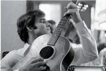  ?? NEW KID IN TOWN ?? Diltz shot this photo of Steve Martin playing guitar in 1969. “He lived right up the road,” the photograph­er recalls. “He’s one of the first guys I saw who had actual oil paintings. That really impressed me.”