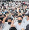  ??  ?? Secondary students hold up their smartphone lights during a protest in Hong Kong in September.