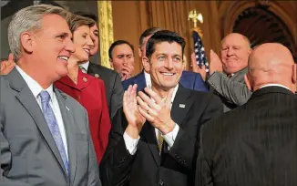  ?? CHIP SOMODEVILL­A / GETTY IMAGES ?? House Majority Leader KevinMcCar­thy of California (left) and House Speaker Paul Ryan of Wisconsin (center) celebrate with fellowHous­e Republican­s following the passage of the Tax Cuts and JobsAct in the Rayburn Roomon Thursday at theU.S. Capitol in...