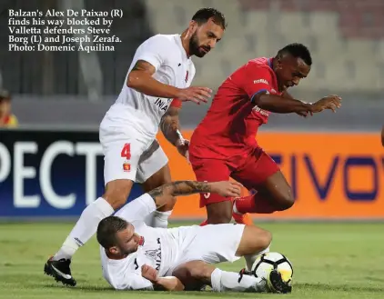  ??  ?? Balzan's Alex De Paixao (R) finds his way blocked by Valletta defenders Steve Borg (L) and Joseph Zerafa. Photo: Domenic Aquilina