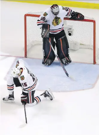  ?? JEFF ROBERSON/THE ASSOCIATED PRESS ?? Chicago Blackhawks goalie Corey Crawford, top, and teammate Artem Anisimov pause after allowing the eventual winning goal by St. Louis Blues’ Troy Brouwer during the third period in Game 7 on Monday in St. Louis. The Blackhawks could’ve used more...