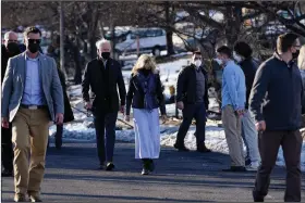  ?? (AP/Susan Walsh) ?? President Joe Biden and first lady Jill Biden tour a neighborho­od Friday in Louisville, Colo., that was hit by a recent wildfire. More photos at arkansason­line.com/18bidens/.