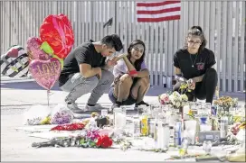  ?? CHRIS CARLSON / ASSOCIATED PRESS ?? Mourners gather at a memorial in Las Vegas, Nev., two days after the Oct. 1 mass shooting there, one of several such incidents that have inflicted a death toll higher than that of the 26 killed in Newtown, Conn., five years ago.