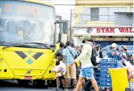  ?? FILE ?? Commuters jostle for space as they prepare to board a Jamaica Urban Transit Company bus at the South Parade terminus in downtown Kingston.